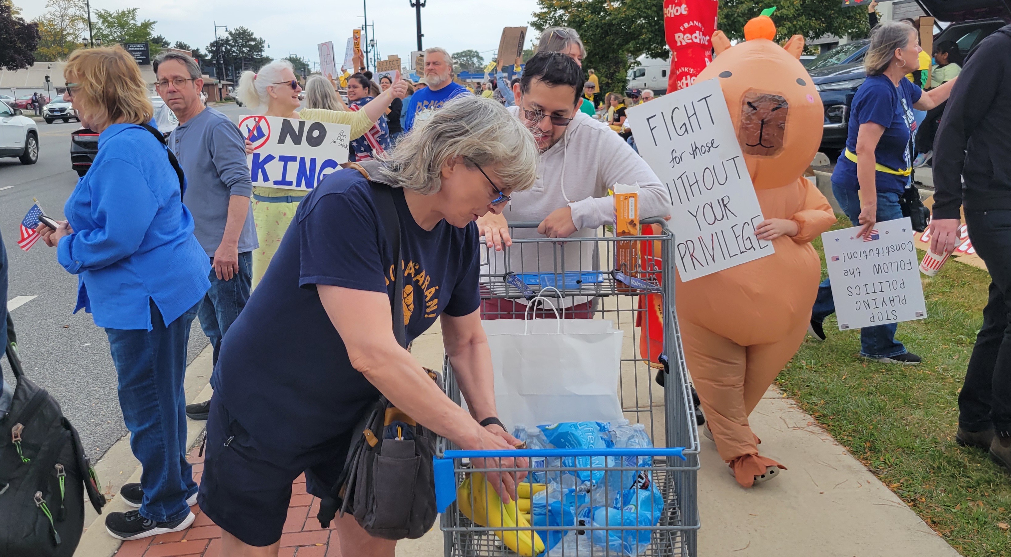 An attendee passing out sandwiches, protein bars, bananas, and water. 
